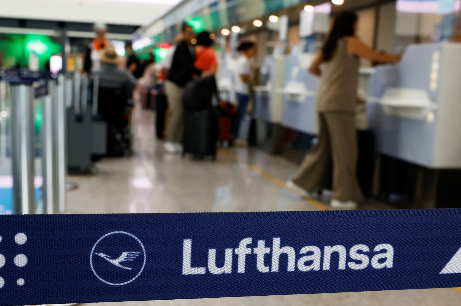 People wait at a Lufthansa check-in at Leonardo da Vinci International Airport, Fiumicino, near Rome, Italy, Sept. 23, 2024. (Reuters Photo)