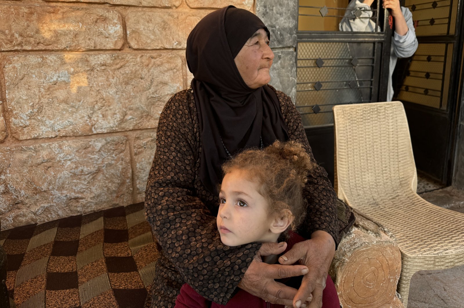 Sade Gorli, a Lebanese Turkman, holds her granddaughter during an interview in the Duris of Baalbek region, Lebanon, Oct. 25, 2024. (AA Photo)