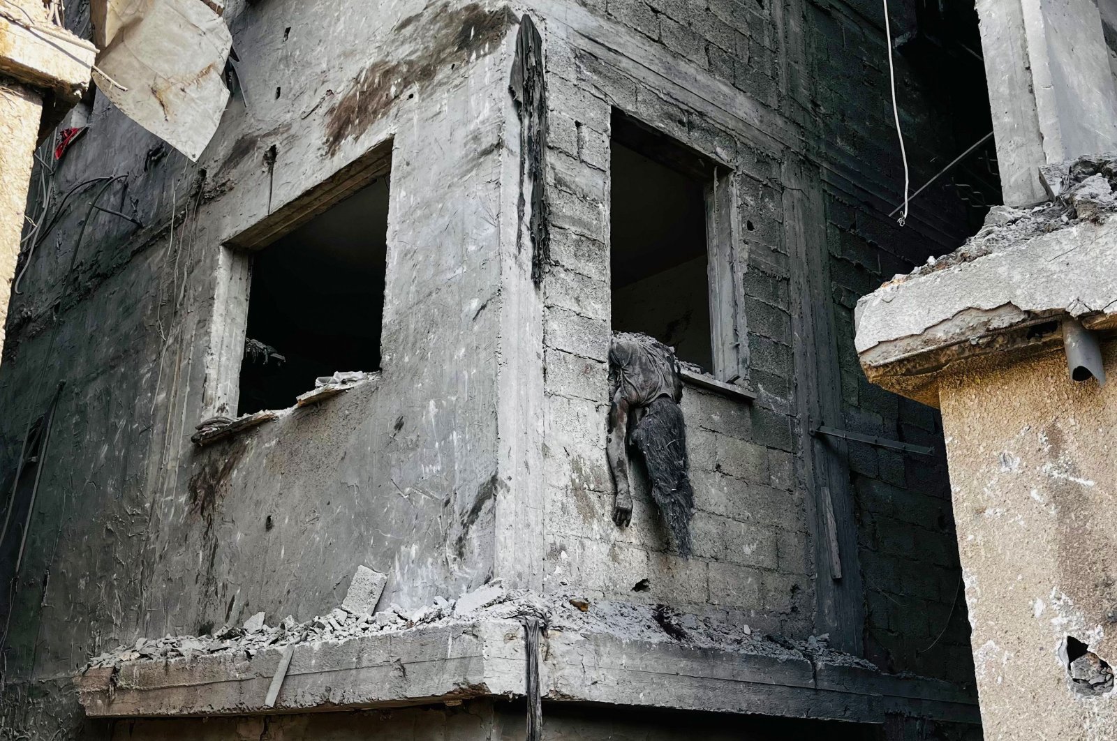 A body hangs out of a window of a building destroyed in an Israeli attack on Beit Lahia, northern Gaza Strip, Palestine, Oct. 29, 2024. (AFP Photo)