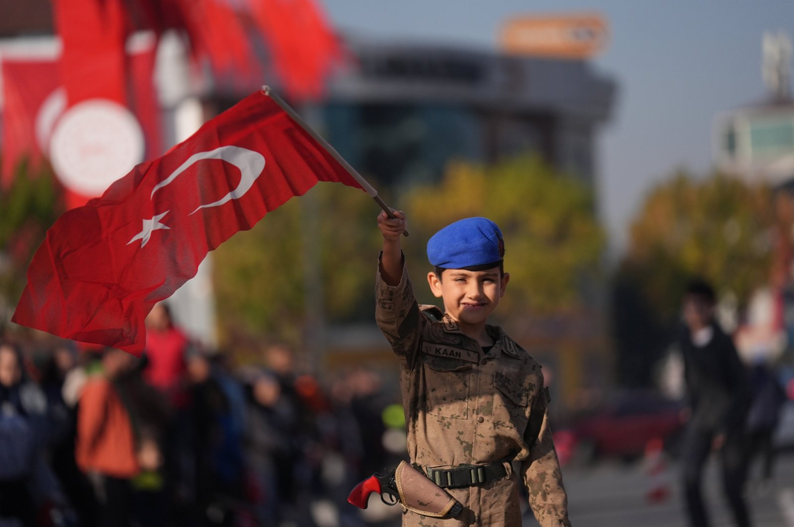 A boy dressed as a soldier waves the Turkish flag during a Republic Day parade, Düzce, Türkiye, Oct. 29, 2024. (AA Photo)