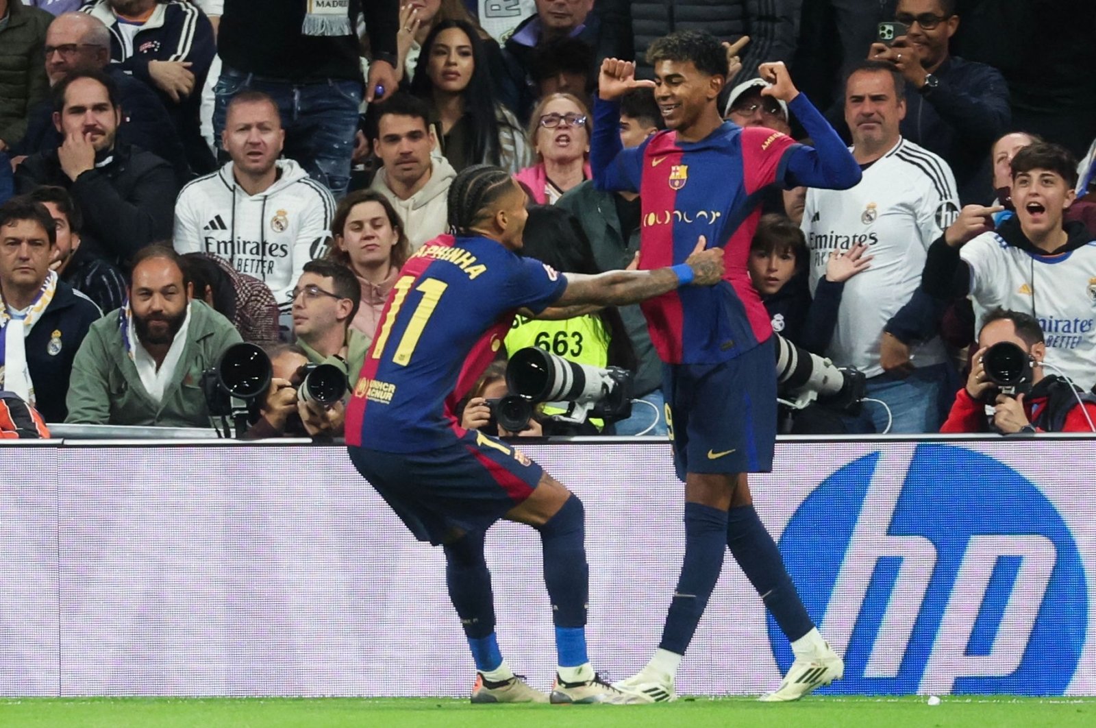 Barcelona&#039;s Lamine Yamal (R) celebrates scoring their third goal with teammate Raphinha during the La Liga match against Real Madrid at the Santiago Bernabeu stadium, Madrid, Spain, Oct. 26, 2024. (AFP Photo)