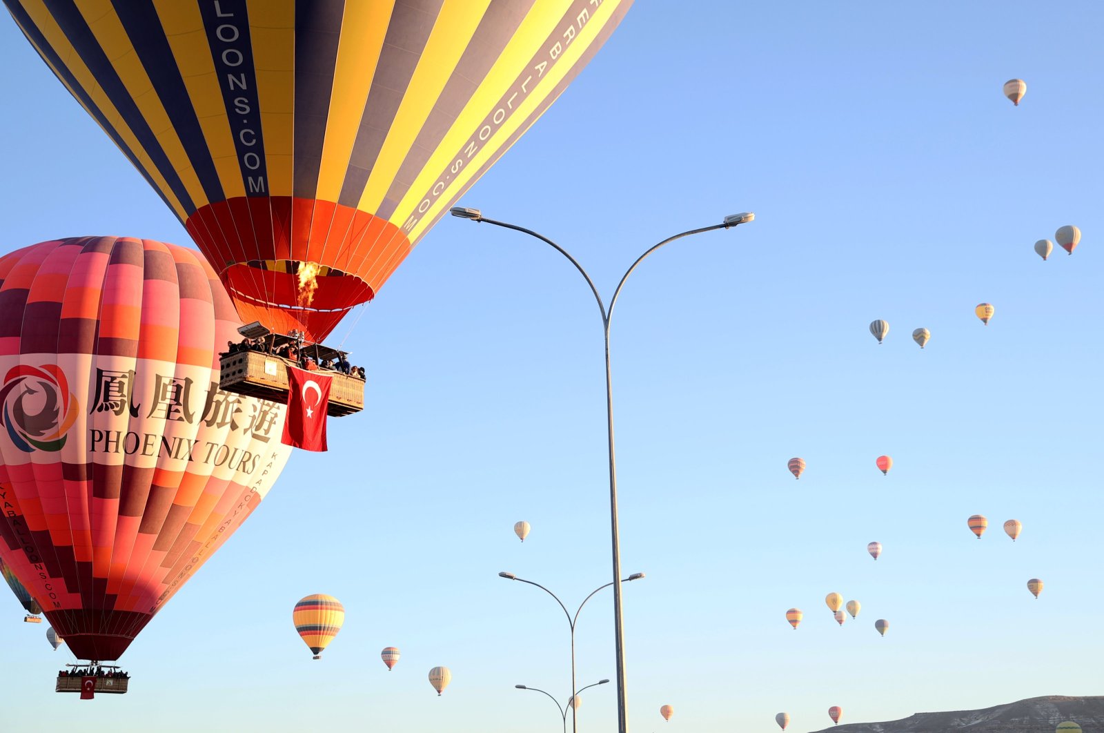 Hot air balloons adorned with Turkish flags fly across the sky in Cappadocia, Türkiye, Oct. 29, 2024. (AA Photo)