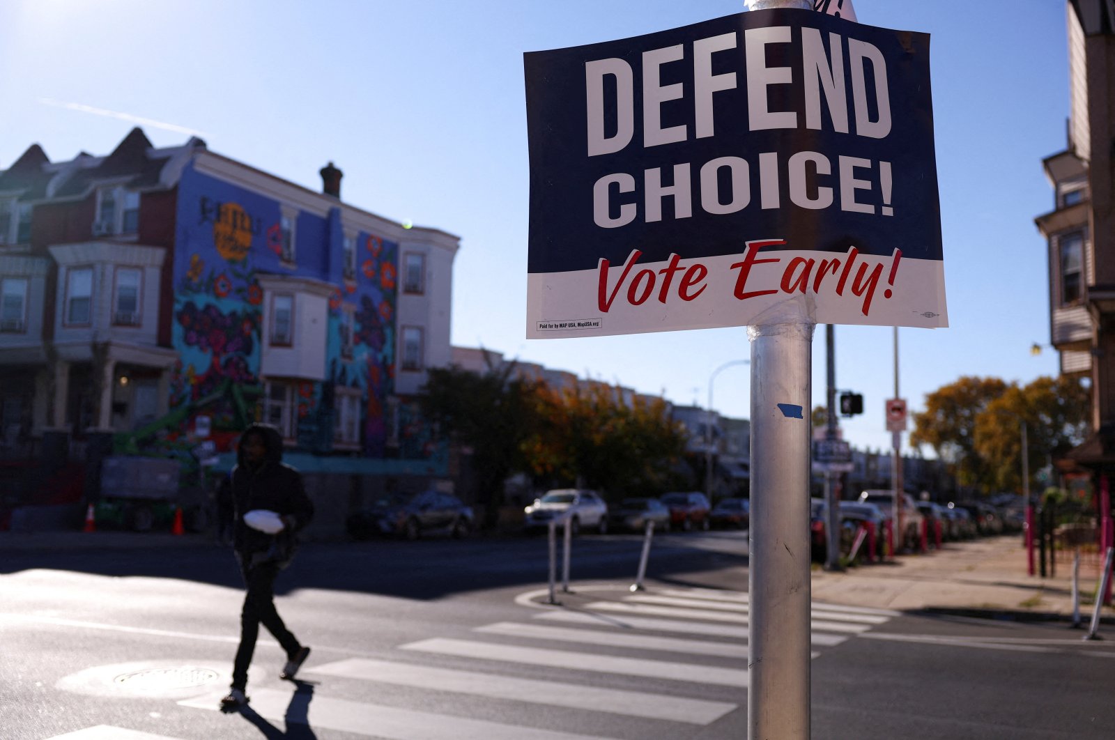 A person walks past a sign encouraging people to vote early in the upcoming U.S. presidential election, in Philadelphia, Pennsylvania, U.S., Oct. 25, 2024. (Reuters Photo)