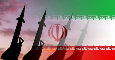 Missiles are seen against the background of the Iranian flag. (Getty Images Photo)