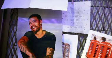 Tributes for Liam Payne are seen next to the phonebox in the Hard Rock Cafe in Piccadilly Circus, which was used on a One Direction album cover, London, U.K., Oct. 18, 2024. (AP Photo)