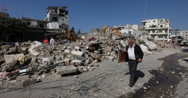 A man walks next to the rubble at the site of an Israeli strike in Sidon, Lebanon, Oct. 30, 2024. (Reuters Photo)