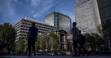 People walk past the Bank of Japan headquarters in Tokyo, Japan, Oct. 30, 2024. (AFP Photo)