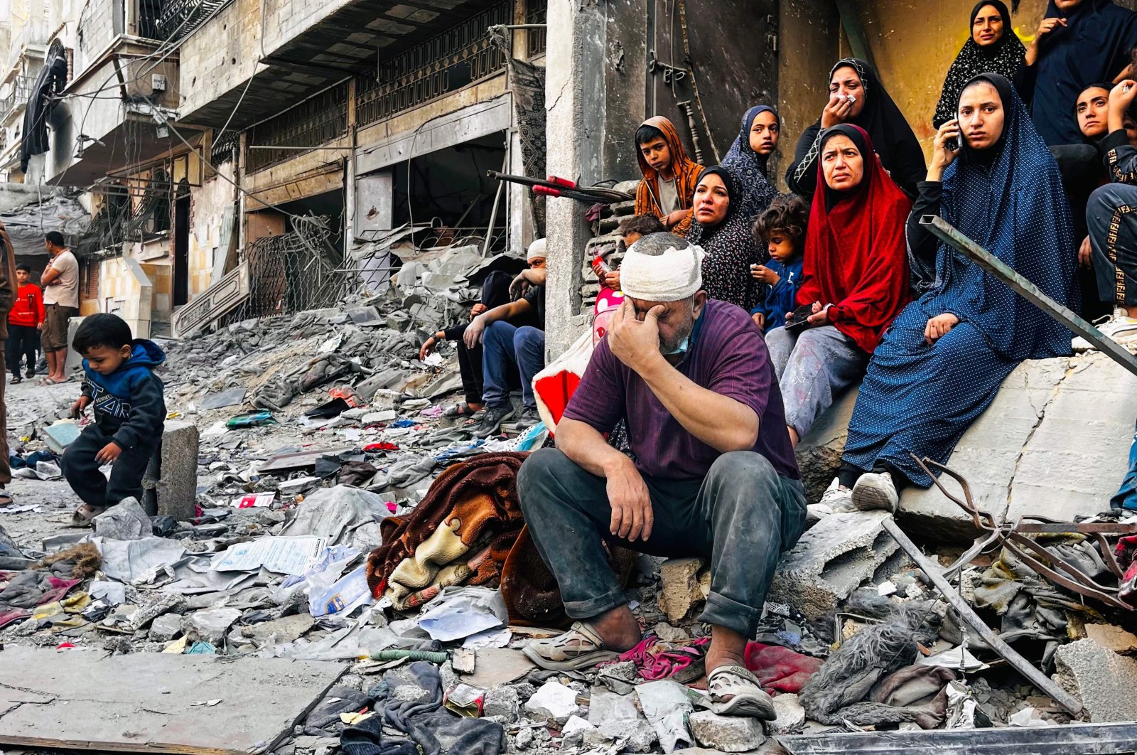 An injured man reacts while sitting on the rubble of a building hit by an Israeli strike in Beit Lahia, Gaza Strip, Palestine, Oct. 29, 2024. (AFP Photo)