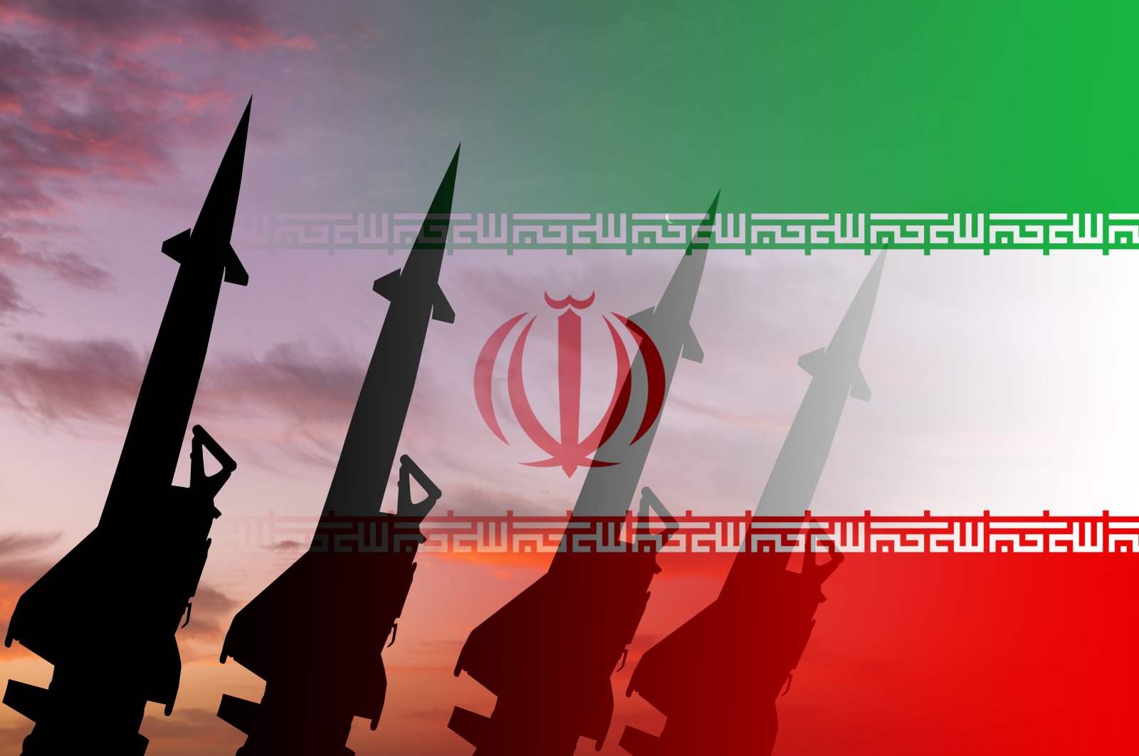 Missiles are seen against the background of the Iranian flag. (Getty Images Photo)