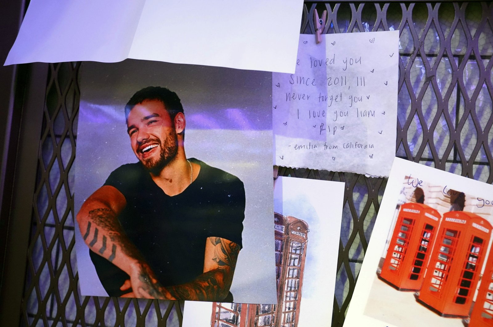 Tributes for Liam Payne are seen next to the phonebox in the Hard Rock Cafe in Piccadilly Circus, which was used on a One Direction album cover, London, U.K., Oct. 18, 2024. (AP Photo)