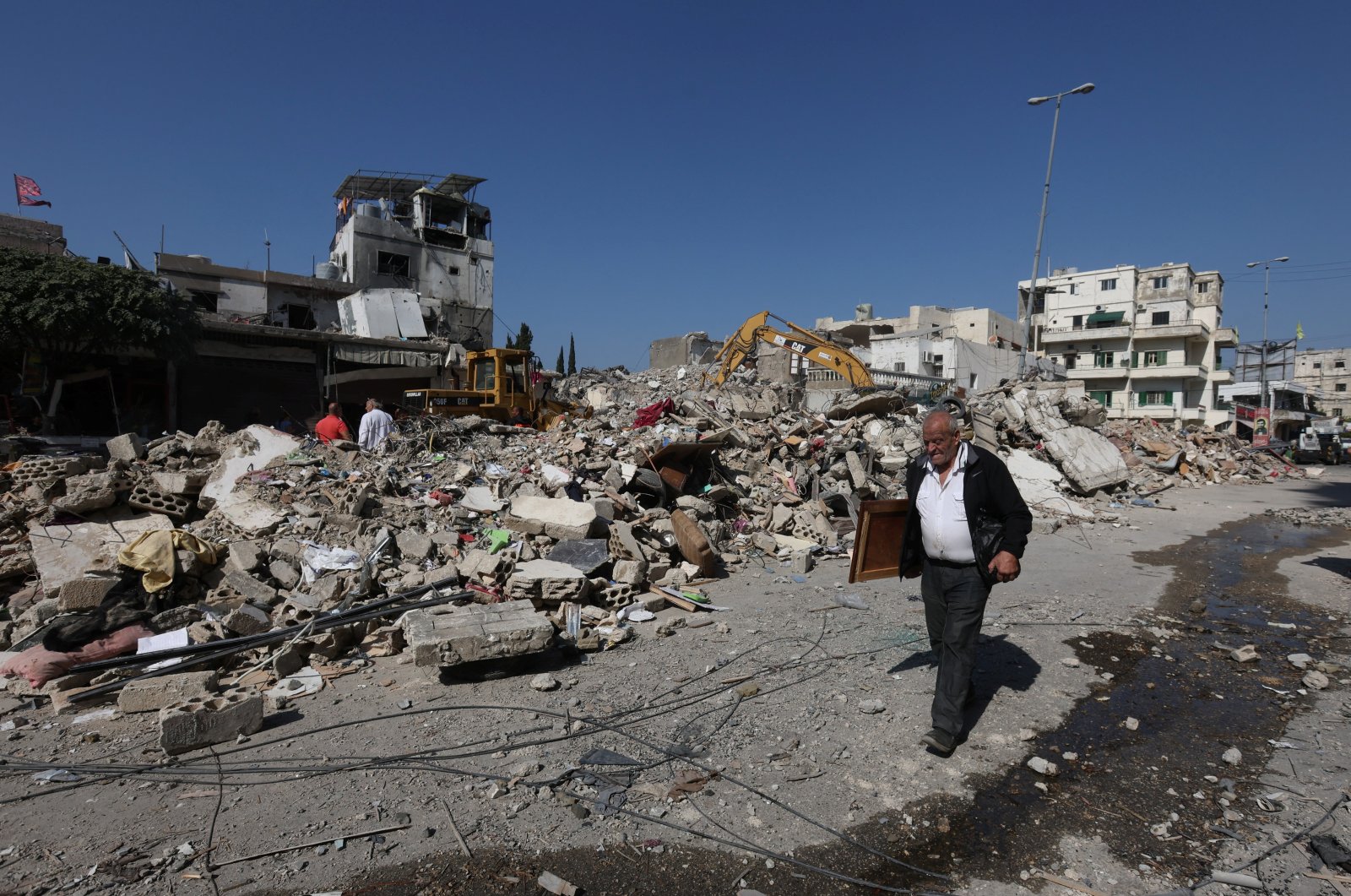 A man walks next to the rubble at the site of an Israeli strike in Sidon, Lebanon, Oct. 30, 2024. (Reuters Photo)