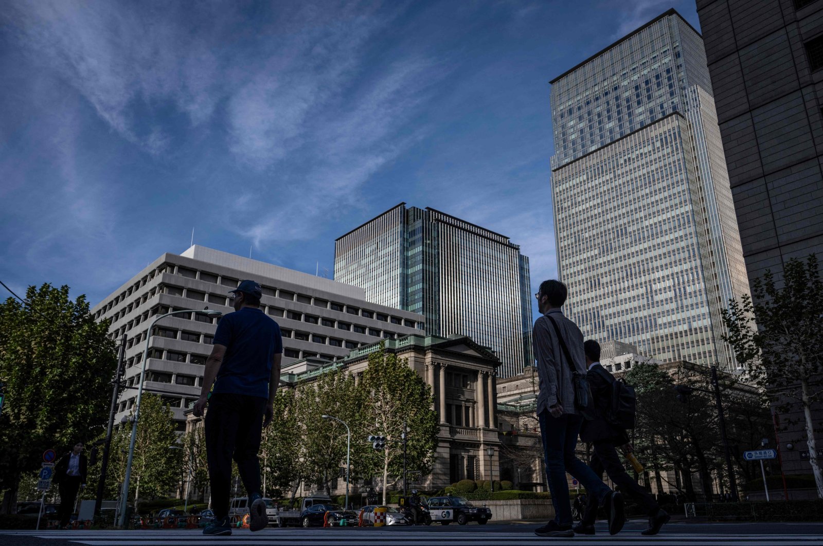 People walk past the Bank of Japan headquarters in Tokyo, Japan, Oct. 30, 2024. (AFP Photo)