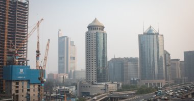 Traffic passes towers and a construction site in the Central Business District, amid smog, Beijing, China, Oct. 25, 2024. (EPA Photo)