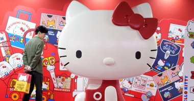 A visitor looks at the giant Hello Kitty display at the exhibition &quot;As I Change, So Does She,&quot; marking the 50th anniversary of Hello Kitty at the Tokyo National Museum, Tokyo, Japan, Oct. 30, 2024. (AP Photo)