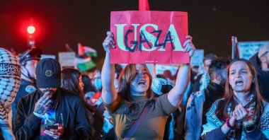 A protester holds up a sign reading "USA" with "Gaza" written on top south of the White House, Washington, DC, Oct. 29, 2024. (AFP Photo)