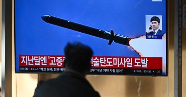 A man watches a television screen showing a news broadcast with file footage of a North Korean missile test, at a train station in Seoul on October 31, 2024. North Korea on October 31 fired a "long-range ballistic missile", South Korea's military said, Pyongyang's first weapons test since Seoul accused it of sending tens of thousands of soldiers to Russia. (Photo by JUNG YEON-JE / AFP)