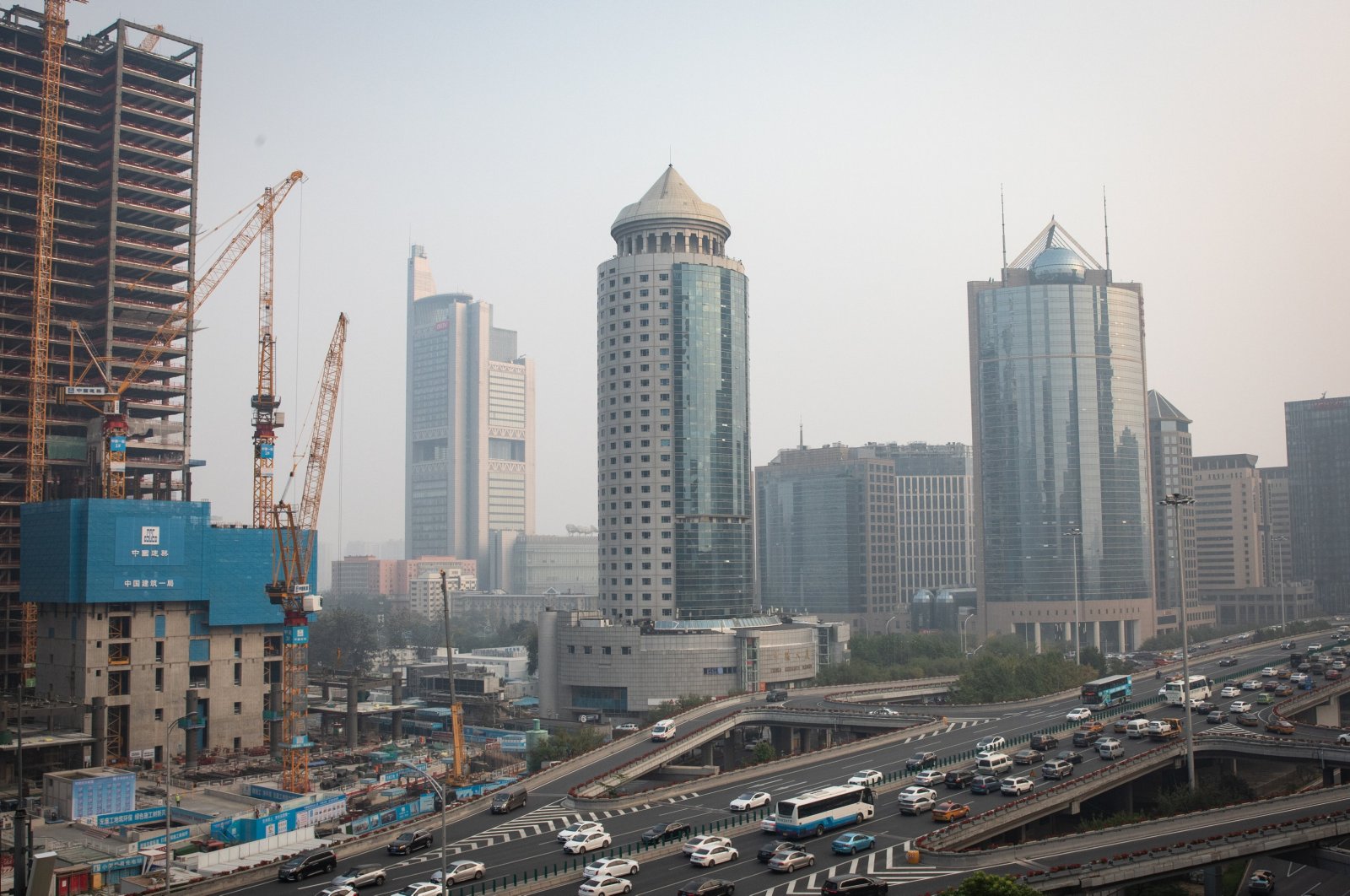 Traffic passes towers and a construction site in the Central Business District, amid smog, Beijing, China, Oct. 25, 2024. (EPA Photo)