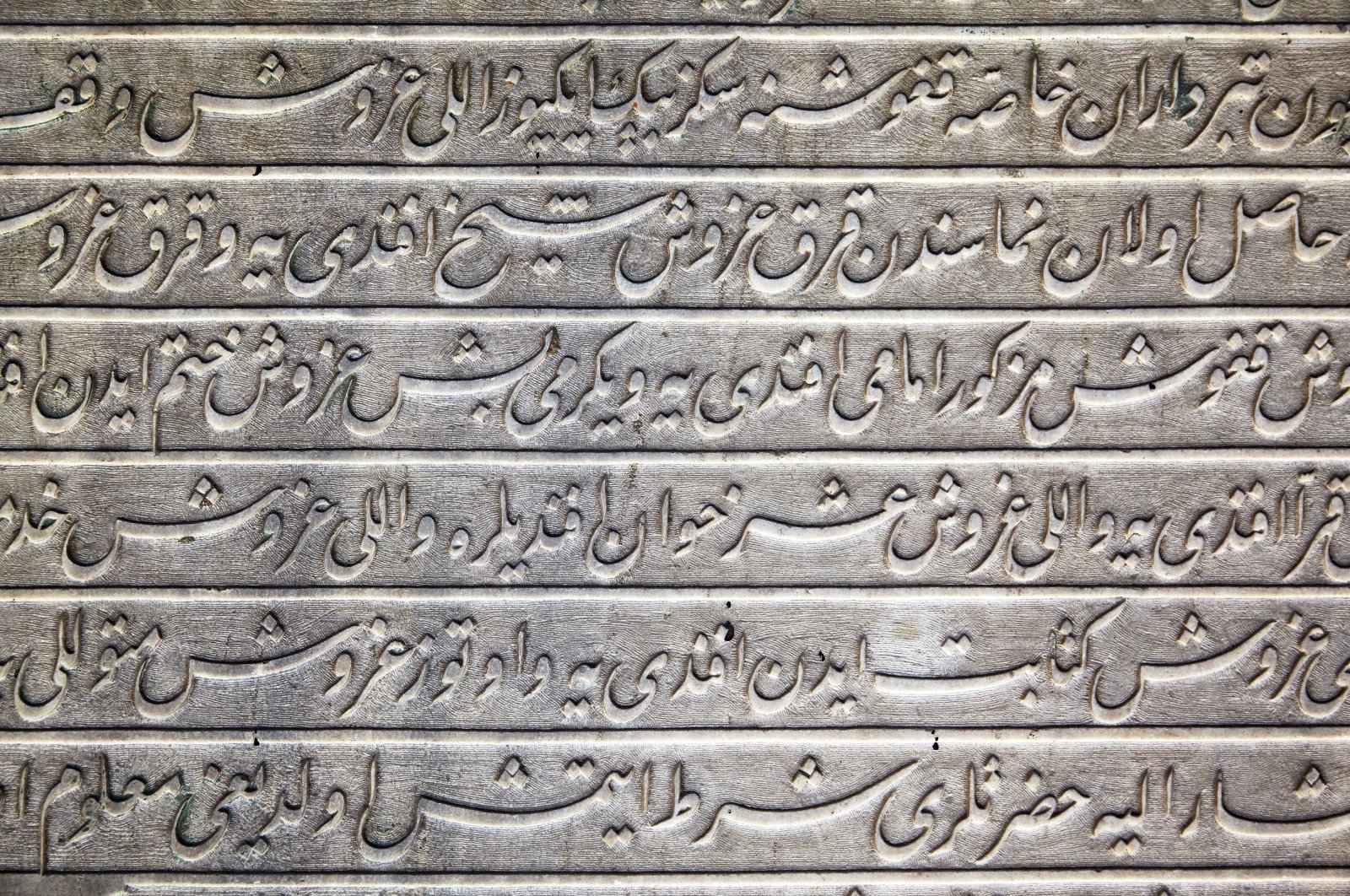 Calligraphic inscriptions in Ottoman Turkish ligature on the marble slab in Topkapi Palace, Istanbul, Türkiye, July 12, 2014. (Shutterstock)