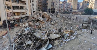 People stand at a site damaged in the aftermath of Israeli strikes, Beirut, Lebanon, Nov. 1, 2024. (Reuters Photo)