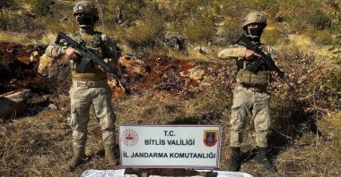 Gendarmerie officers stand over a pile of rocket launchers seized in a raid of a PKK hideout in southeastern Bitlis province, Türkiye, Oct. 31, 2024. (DHA Photo)