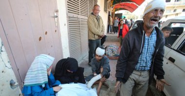 An injured Palestinian man reacts as others surround the body of a victim killed by an Israeli strike on the Nuseirat refugee camp, in front of the al-Aqsa Martyrs hospital, Deir el-Balah, Gaza Strip, Palestine, Nov. 1, 2024. (AFP Photo)