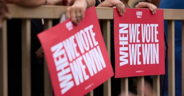 People hold placards as Democratic vice presidential nominee Minnesota Governor Tim Walz delivers remarks at a campaign rally, Tucson, Arizona, U.S., Nov. 2, 2024. (EPA Photo)