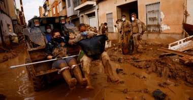 Spanish civilian and military rescuers are transported with an excavator in Massanassa, near Valencia, Spain, Nov. 3, 2024. (Reuters Photo)