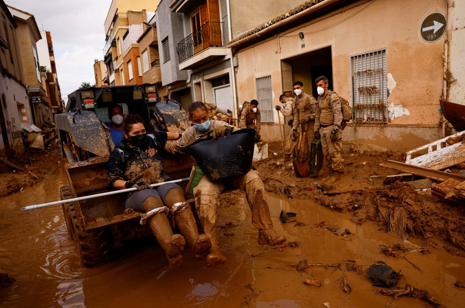 Spanish civilian and military rescuers are transported with an excavator in Massanassa, near Valencia, Spain, Nov. 3, 2024. (Reuters Photo)