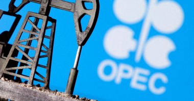 A 3D printed oil pump jack is seen in front of the displayed OPEC logo in this illustrated picture, April 14, 2020. (Reuters Photo)