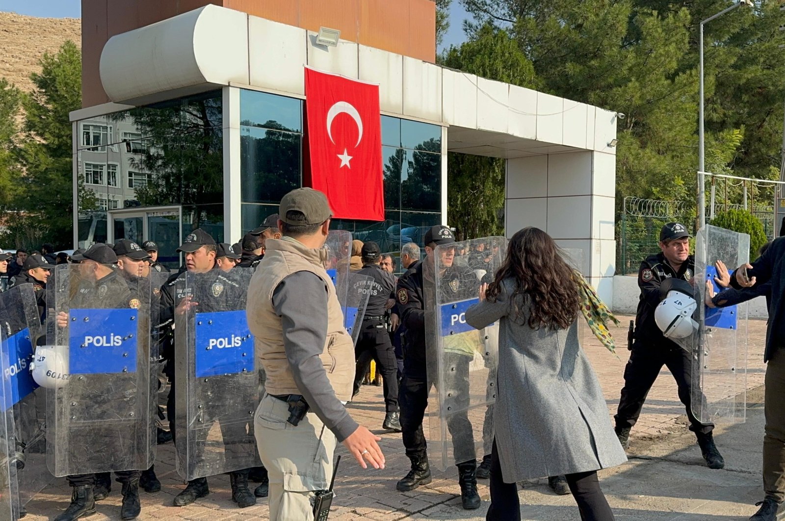 Peoples&#039; Equality and Democracy Party (DEM Party) supporters try to enter the municipality building after a trustee was appointed, Mardin, southeastern Türkiye, Nov. 4, 2024. (İHA Photo)