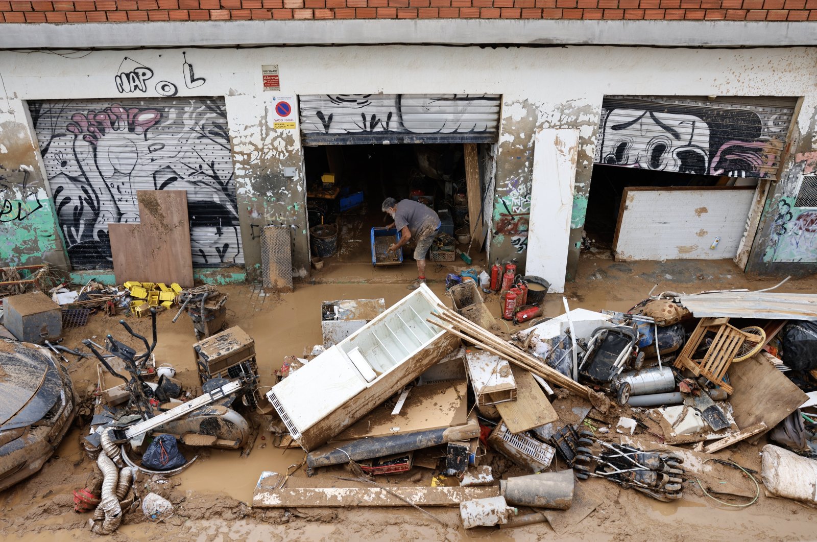 A man clears the debris and mud on his property following last week&#039;s floods in the municipality of Sedavi, province of Valencia, Spain, Nov. 4, 2024. (EPA Photo)