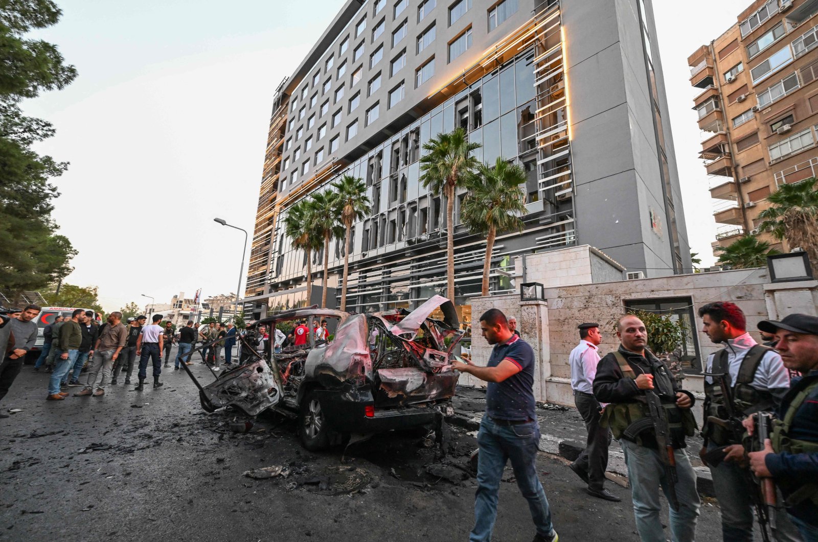 Syrian emergency and security services inspect the wreckage of a car that exploded in the Syrian capital Damascus, Oct. 21, 2024. (AFP File Photo)