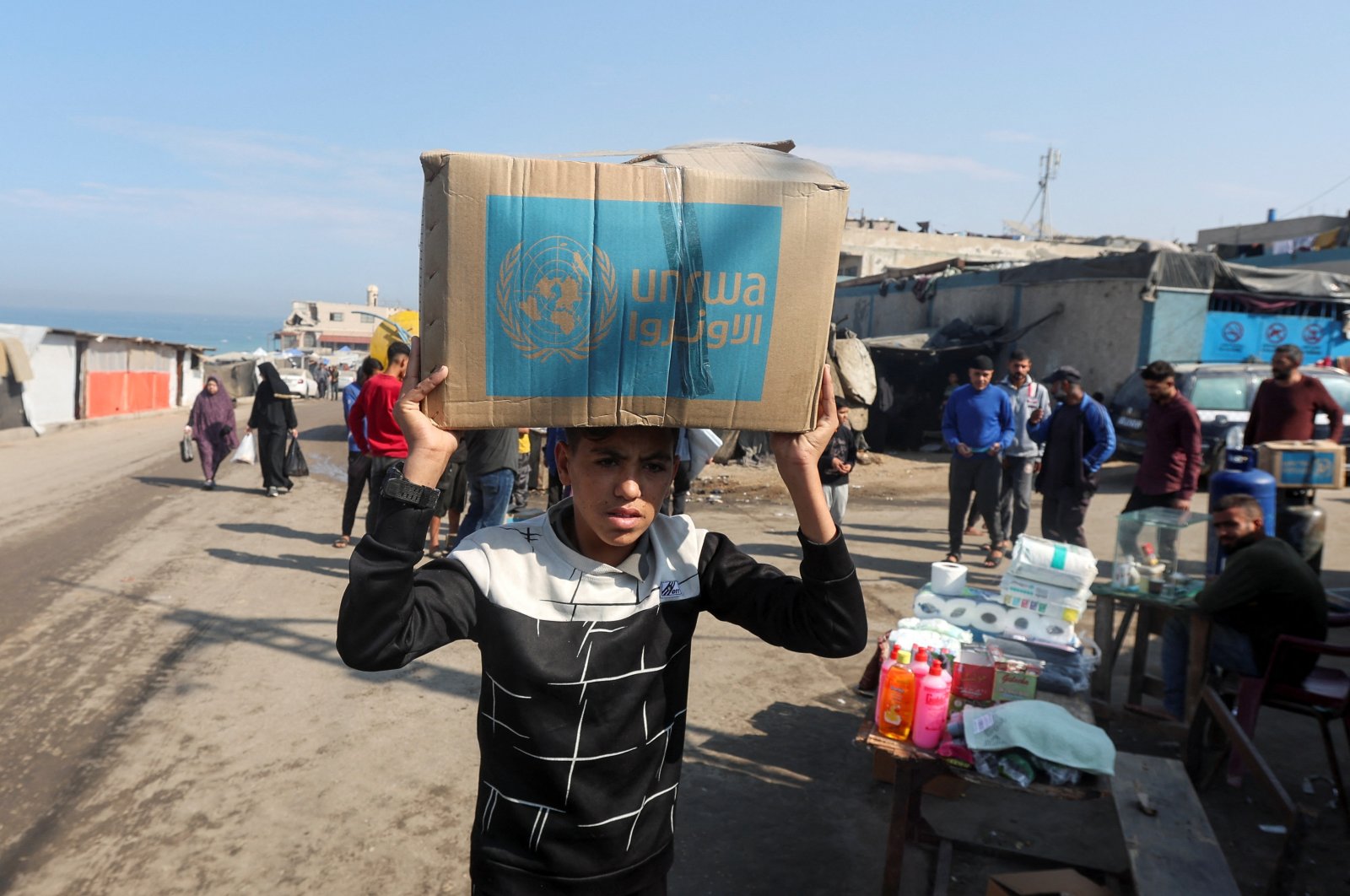 A Palestinian boy carries an aid box distributed by the United Nations Relief and Works Agency (UNRWA), in Deir Al-Balah, central Gaza Strip, Nov. 4, 2024. (Reuters Photo)