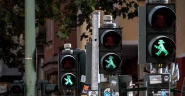 A row of pedestrian traffic signals featuring the former East German &quot;Ampelmaennchen&quot; (&quot;little traffic signal man&quot;) show green at a pedestrian crossing, Berlin, Germany, Sept. 28, 2024. (AFP Photo)