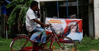 A man cycles past a poster of Democratic presidential nominee U.S. Vice President Kamala Harris in Thulasendrapuram, Tamil Nadu, India, Nov. 4, 2024. (Reuters Photo)