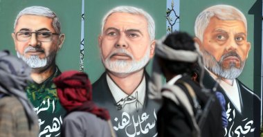 Houthi supporters pass paintings depicting (R-L) the two late Hamas leaders Yahya Sinwar and Ismail Haniyeh and late Hezbollah military commander Ibrahim Aqil on display during a rally in solidarity with the Lebanese and Palestinian people, Sanaa, Yemen, Oct. 18, 2024. (EPA Photo)