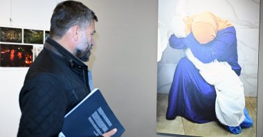 A visitor examines a photograph at the Istanbul Photo Awards exhibition in Brussels, Belgium, Nov. 4, 2024. (AA Photo)