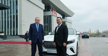 President Erdoğan and Kyrgyz President Sadyr Japarov pose in front of the Togg vehicle Erdoğan gave to Japarov, Bishkek, Kyrgyzstan, Nov. 5, 2024. (DHA Photo)