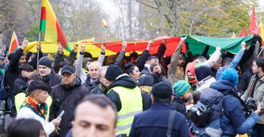 PKK terrorist sympathizers hold up a large PKK banner during a rally calling to lift the ban on their terrorist organization, Berlin, Germany, Nov. 18, 2023. (Getty Images Photo)