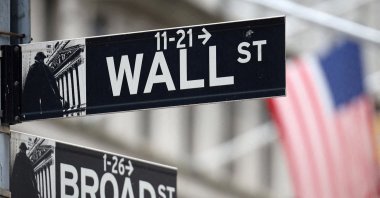 A Wall Street sign hangs in front of a U.S. Flag outside the New York Stock Exchange (NYSE) in New York City, U.S., Sept. 18, 2024. (Reuters File Photo)