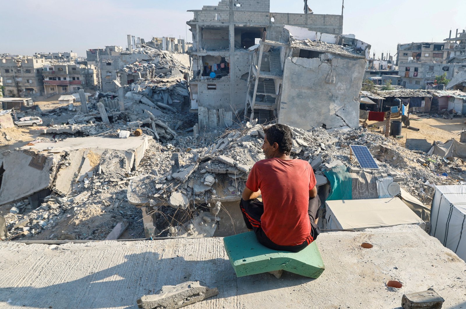 A Palestinian man sits on the rubble of a house destroyed in the Israeli military offensive, amid the Israel-Palestine conflict, in Khan Younis, southern Gaza Strip, Palestine, Nov. 4, 2024. (Reuters Photo)