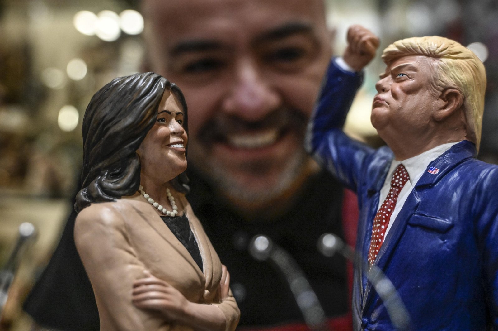 Genny Di Virgilio, a nativity scene artisan from San Gregorio Armeno, looks at his terracotta figurines of U.S. Vice President Kamala Harris and Republican Presidential candidate Donald Trump, in Naples, Italy, Nov. 2, 2024. (EPA Photo)