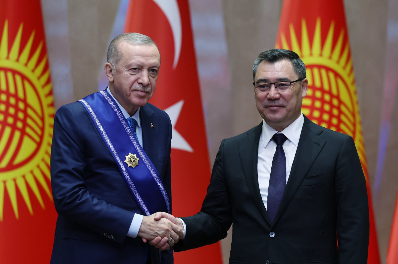 Kyrgyz President Sadyr Japarov (R) shakes hands with President Recep Tayyip Erdoğan after presenting him with a medal of honor at their High-Level Strategic Cooperation Council meeting in the capital of Bishkek, Kyrgyzstan, Nov. 5, 2024. (AA Photo)