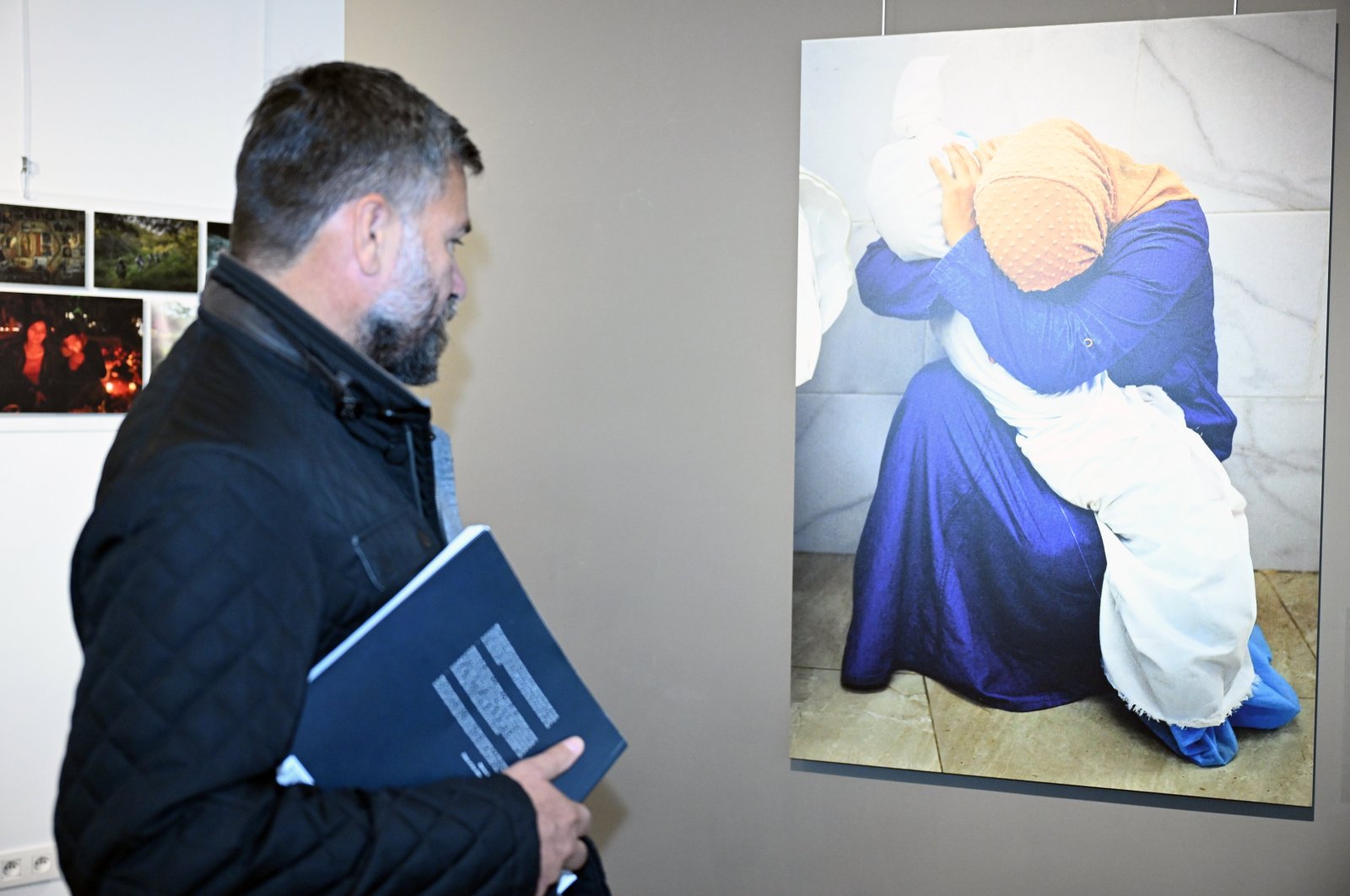 A visitor examines a photograph at the Istanbul Photo Awards exhibition in Brussels, Belgium, Nov. 4, 2024. (AA Photo)