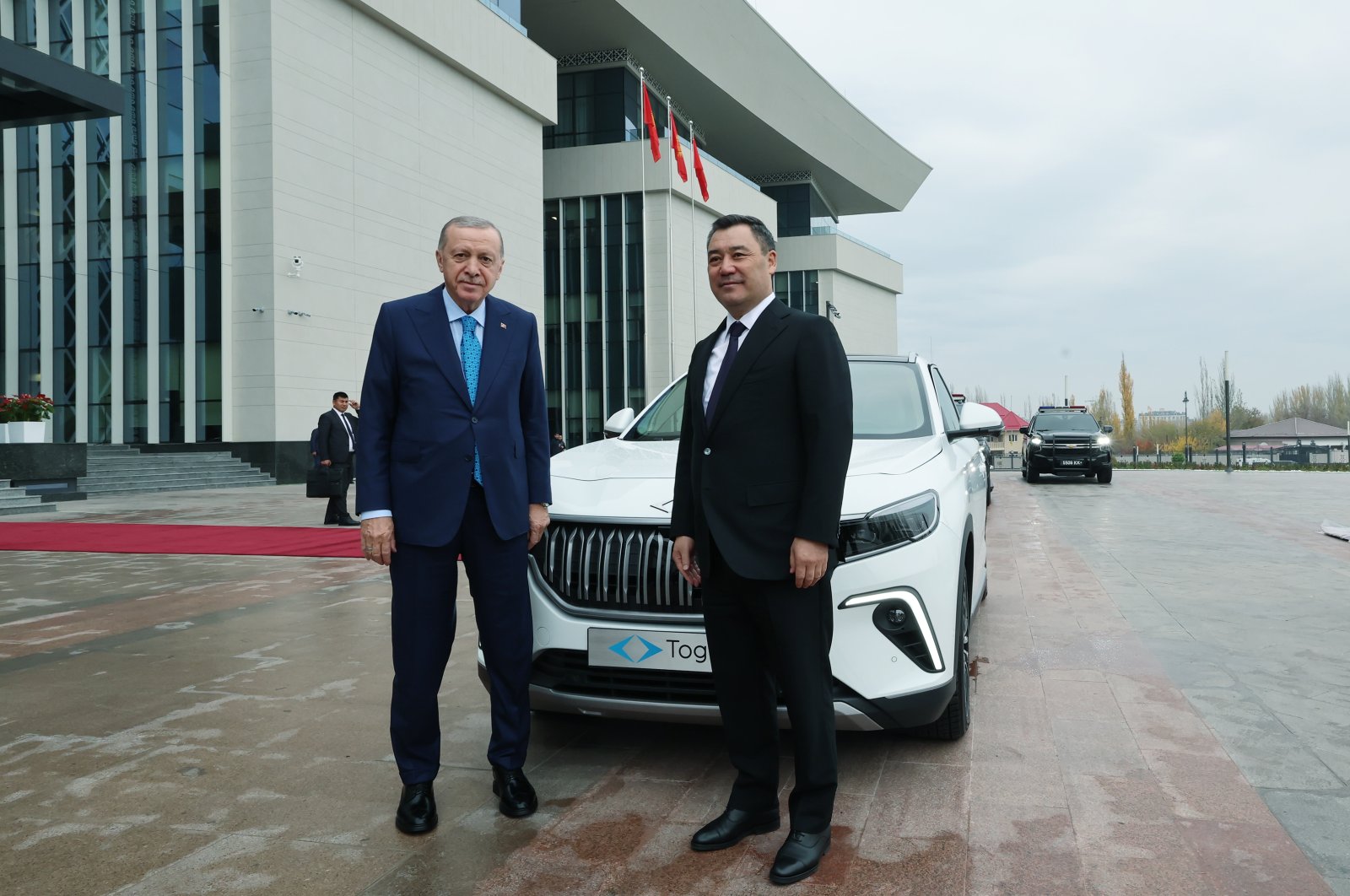 President Erdoğan and Kyrgyz President Sadyr Japarov pose in front of the Togg vehicle Erdoğan gave to Japarov, Bishkek, Kyrgyzstan, Nov. 5, 2024. (DHA Photo)