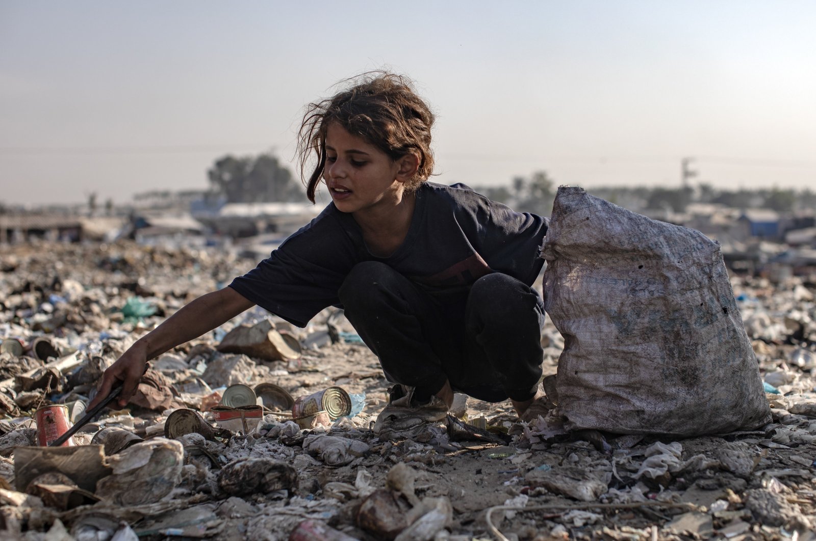 A Palestinian child sorts through garbage while collecting plastic from a landfill, amid a shortage of cooking gas and fuel, Khan Younis, southern Gaza Strip, Palestine, Nov. 4, 2024. (EPA Photo)