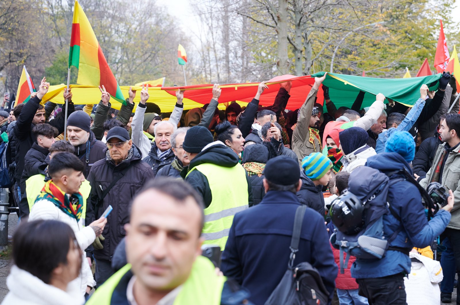 PKK terrorist sympathizers hold up a large PKK banner during a rally calling to lift the ban on their terrorist organization, Berlin, Germany, Nov. 18, 2023. (Getty Images Photo)