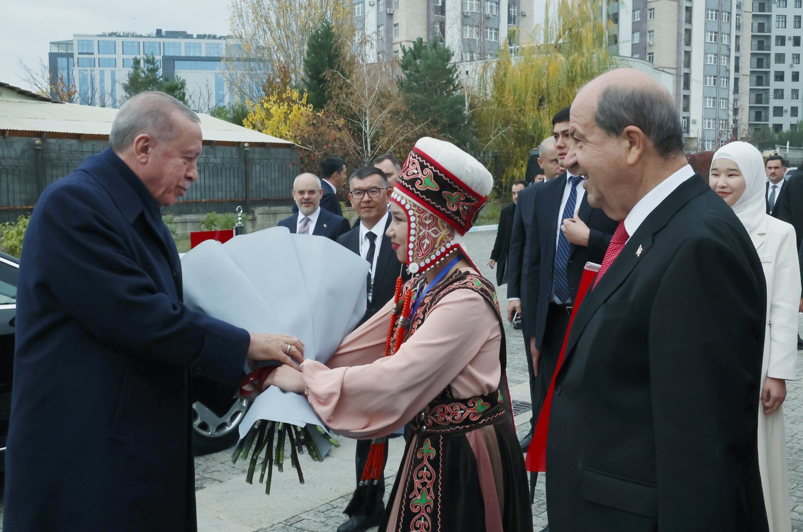 President Recep Tayyip Erdoğan (L) is welcomed by a student as he arrives at Manas University in Bishkek, Kyrgyzstan, Nov. 5, 2024. (AA Photo)