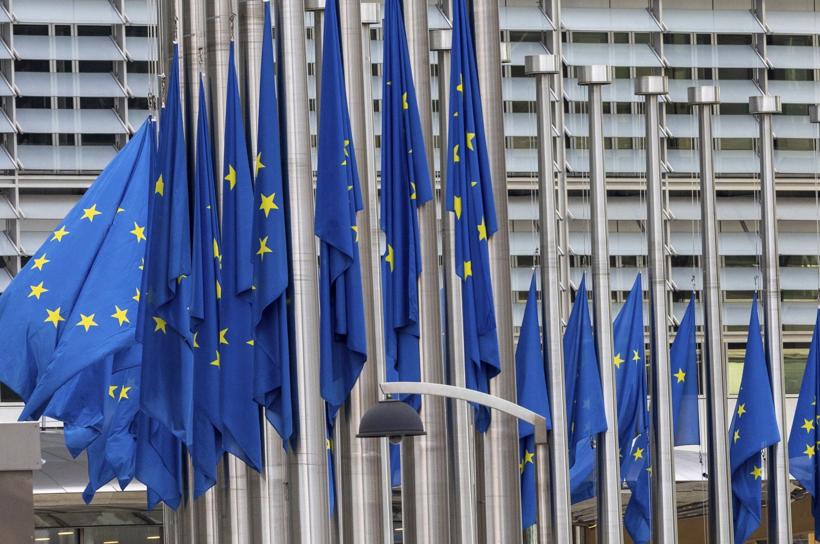 European Union flags flap in the wind at half-staff, in honor of European Parliament President David Sassoli, at EU headquarters in Brussels, Tuesday, Jan. 11, 2022. (AP File Photo)