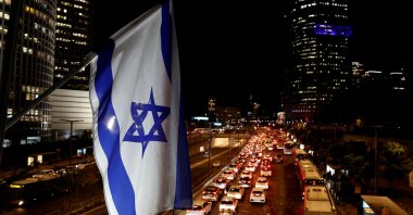An Israeli national flag flies over a city highway during rush hour, Tel Aviv, Israel, Nov. 4, 2024. (Reuters Photo)